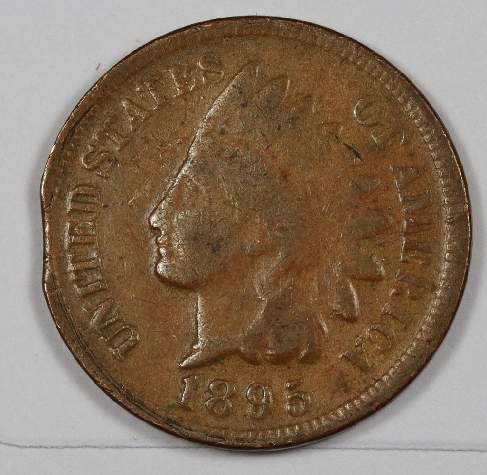 1895 Indian Head penny clipped planchet error showing section of the coin edge missing from improper strip feeding
